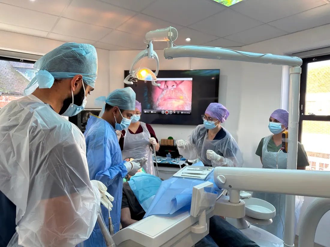 Implant surgeons operating during a hands-on clinical session